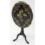 A 20thC ebonised occasional table with a shaped papier mache top with painted decoration and inlaid