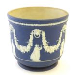 A blue Wedgwood Jasperware jardiniere / planter with relief decoration of classical figures with