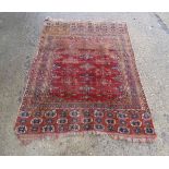 Rug / Carpet : an antique Nomadic rug with wine ground , black , orange and salmon pink colours ,