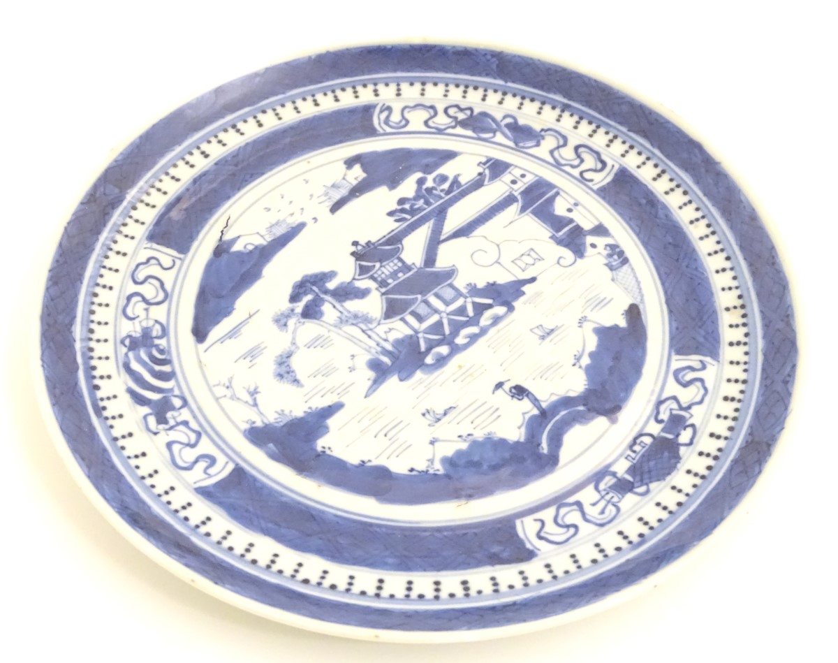 A Chinese blue and white plate with hand painted decoration depicting a pagoda on an island, - Image 5 of 6