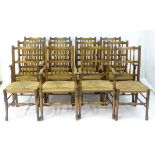 A set of twelve (8+4) mid 20thC dining chairs with shaped top rails, spindle supported backrests,