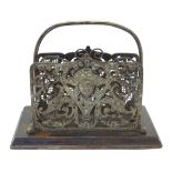 A late 19thC / early 20thC cast brass three division letter rack decorated with a classical face