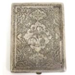 A white metal cigarette case with engraved decoration depicting birds and scrolling detail.