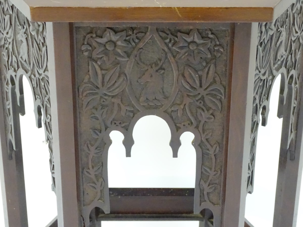 A walnut Liberty style table with a hexagonal carved top above six matching carved facades with - Image 8 of 13