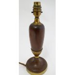 A wooden with brass detail pedestal table lamp, standing 12 1/2" high.