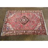 Rug / Carpet : With a red background and a floral and geometric design border and diamond central