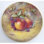 A Royal Worcester plate with hand painted decoration depicting a study of a still life of fruit,