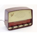 A 1950s / 1960s Marconi Marconiphone T69DA valve radio, with burgundy cover and white detail,