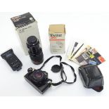 A late-20thC Nikon 'EM' SLR 35mm film camera, together with Vivitar telephoto lens and flash unit,