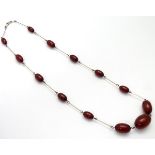 A necklace set with graduated cherry amber coloured beads 18" long CONDITION: Please