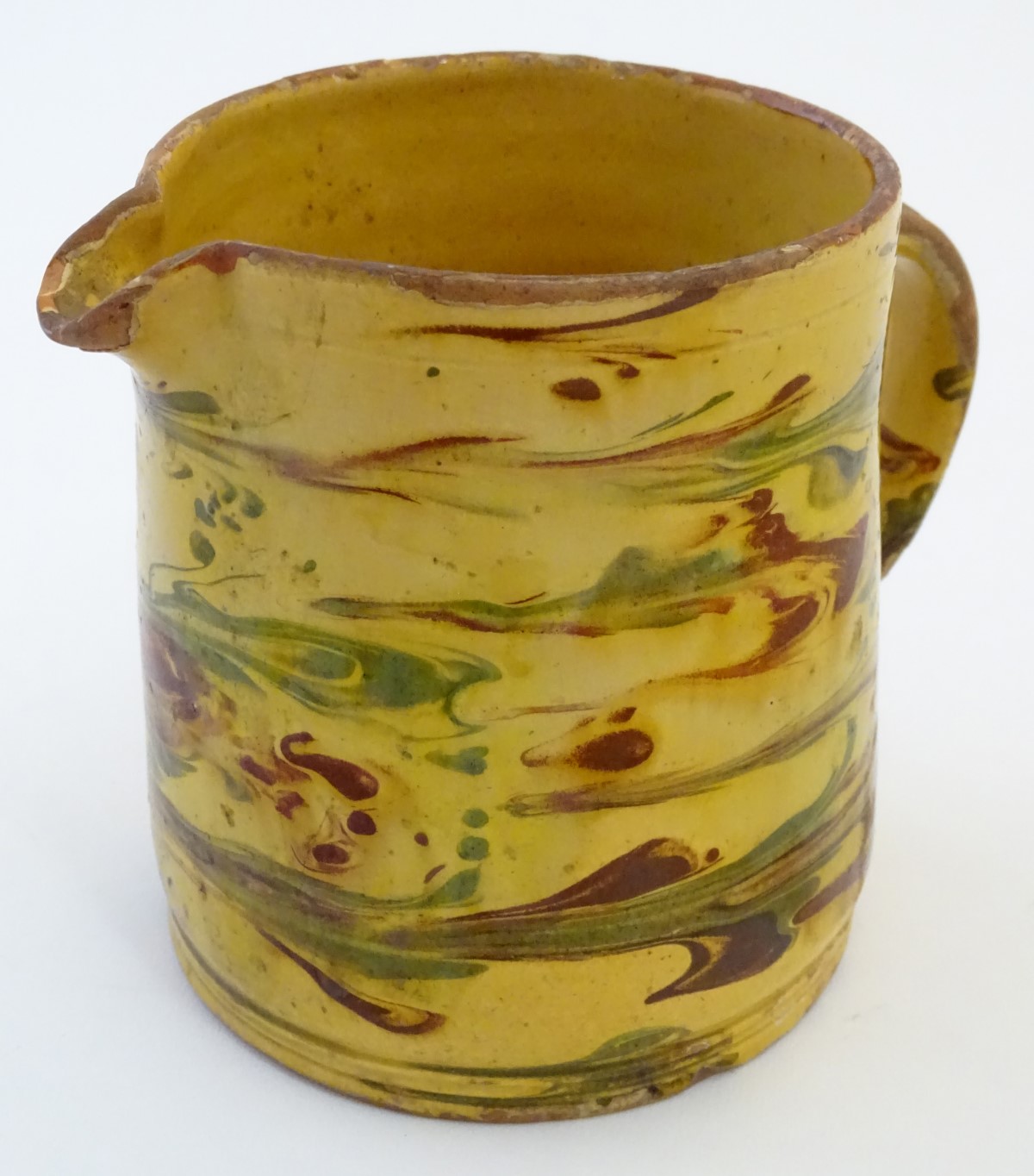 A 19thC studio pottery slipware jug with a yellow ground. Indistinct incised mark under. Approx. - Image 4 of 7