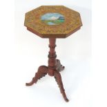 A late 19thC / early 20thC Tyrolean table with an octagonal top decorated with vignettes depicting