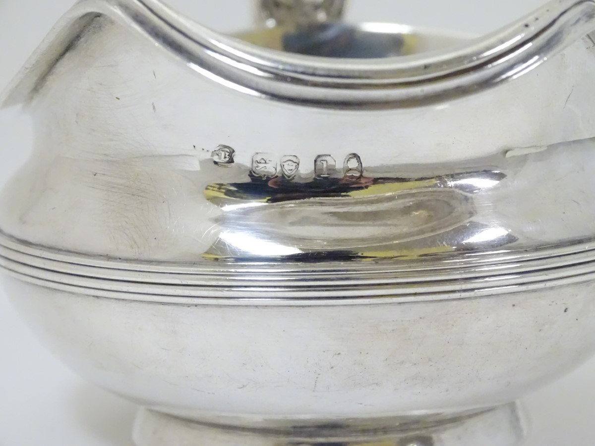 A silver jug / sauce boat with floral decoration to handle hallmarked London 1826 maker William - Image 7 of 8
