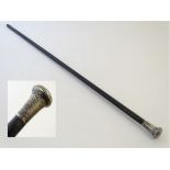 A Victorian ebony cane, with hallmarked silver knop.