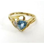 A 10k gold ring set with central topaz and chip set diamonds CONDITION: Please