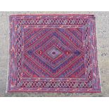 Rug / Carpet : A Turkish handmade woollen rug with a radiating diamond design on a mainly claret