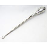 A silver handled button hook hallmarked Birmingham 1907 maker Crisford & Norris.