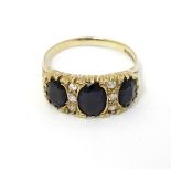A 9ct gold ring set with white and dark stones CONDITION: Please Note - we do
