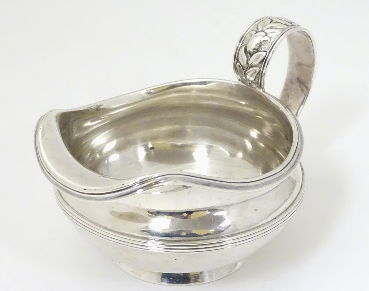 A silver jug / sauce boat with floral decoration to handle hallmarked London 1826 maker William - Image 2 of 8
