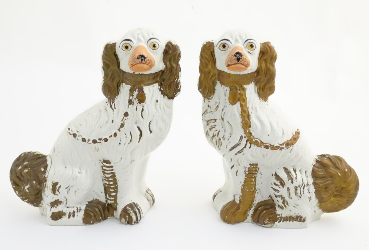 A pair of large Staffordshire flat back spaniel dogs, with gilt chain collar detail.