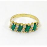 An 18ct gold ring set with green and white stones CONDITION: Please Note - we do