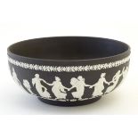 A black Wedgwood Jasperware bowl decorated with classical figures, the Dancing Hours,