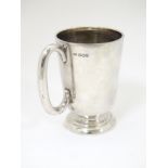 A silver mug with loop handles hallmarked Sheffield 1954 maker Walker & hall.