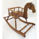 Toy: A 20thC mahogany rocking horse chair / child's rocker with a carved horse head and spindle