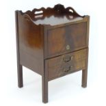 A mid 19thC mahogany night table with a shaped up stand with pierced carrying handles above a