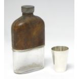 WITHDRAWN FROM AUCTION A glass hip flask with half leather covering together with a silver plate