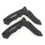 A boxed Gerber tactical lock knife, 3 3/4" blade with saw and composite grips,