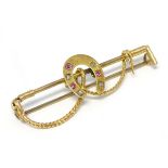 A gold bar brooch set with rubies and diamonds 2" wide CONDITION: Please Note - we