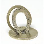 A silver menu holder / table place card holder with horse shoe decoration.