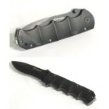 A Magnum by Boker tactical lock knife, with composite grip and 4 1/2" blade with saw.