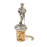 A novelty bottle stopper surmounted by a figure of a golfer.