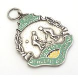 Hockey : A white metal and enamel fob depicting 2 hockey players and titled 1952 Rangoon Burma