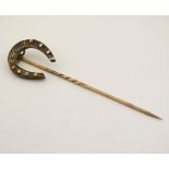 A gilt metal stick pin surmounted by a horseshoe 3" high CONDITION: Please Note -