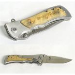 A Browning stainless steel skinning lock knife, with burr maple grips,