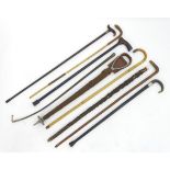 A quantity of assorted sticks / canes and riding crops,