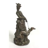 A 21stC cast sculpture of a lady in Victorian dress walking a dog. Approx. 9 ¼” high.