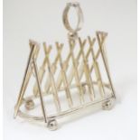 A silver plate novelty toast rack, the bars formed as cricket bats,