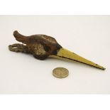 A novelty desk top letter / pepper clip formed as the head of a game bird,