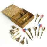A box of vintage darts some with feather flights contained within a wooden box. Approx. 7 pieces.