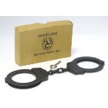 A pair of handcuffs, marked The Peerless Handcuff Co., Springfield, boxed with key.