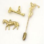 A 9ct gold charm formed as horse together with a 9ct gold hunting horn and a gold plated stick pin