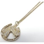 A silver pendant and chain, the pendant with horseshoe and horse head decoration.