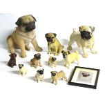 A quantity of assorted pug figurines, to include three ceramics examples, by Sylvac,