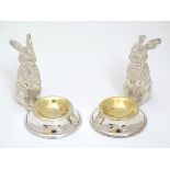 A pair of novelty table salts with cast bunny rabbit decoration.