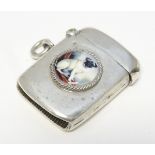 A hallmarked silver vesta case with later applied enamel cabochon depicting a pug dog.