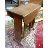 A Cotswold school style oak drop flap table with a chamfered frame and exposed construction.